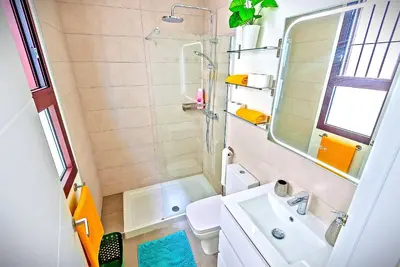 a small bathroom with a sink and a shower at Jacuzzi & Pool House w Rooftop Terrace, Garden BBQ in El Puerto de Santa María