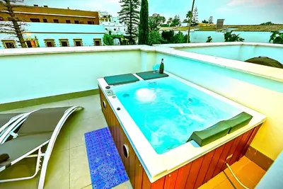 a swimming pool on top of a building at Jacuzzi & Pool House w Rooftop Terrace, Garden BBQ in El Puerto de Santa María