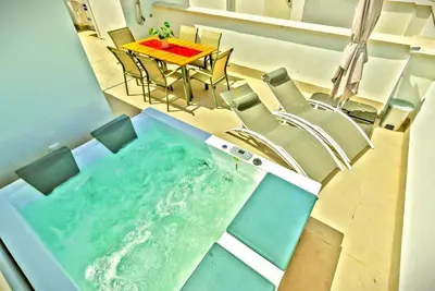 an overhead view of a tub with a table and chairs at Jacuzzi & Pool House w Rooftop Terrace, Garden BBQ in El Puerto de Santa María