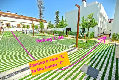 a building with a parking lot with a sign at Jacuzzi & Pool House w Rooftop Terrace, Garden BBQ in El Puerto de Santa María