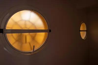 a window in a room with a clock on it at GINVA - Apartamento en pleno centro 1 in El Puerto de Santa María