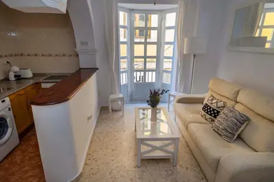 a living room with a couch and a table at GINVA - Apartamento en pleno centro 1 in El Puerto de Santa María