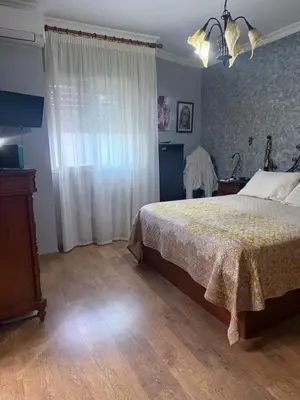 a bedroom with a bed and a dresser and a window at Casa Coplas muy cerca de la playa in Sanlúcar de Barrameda