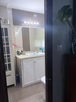 a bathroom with a sink and a toilet and a mirror at Casa Coplas muy cerca de la playa in Sanlúcar de Barrameda