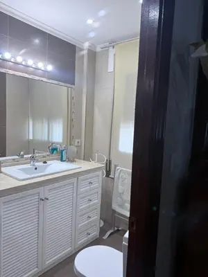 a bathroom with a sink and a toilet and a mirror at Casa Coplas muy cerca de la playa in Sanlúcar de Barrameda