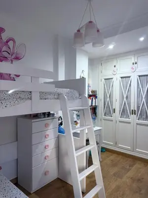 a bunk bed with a ladder in a room at Casa Coplas muy cerca de la playa in Sanlúcar de Barrameda