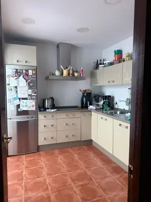 a kitchen with a stainless steel refrigerator and cabinets at Casa Coplas muy cerca de la playa in Sanlúcar de Barrameda