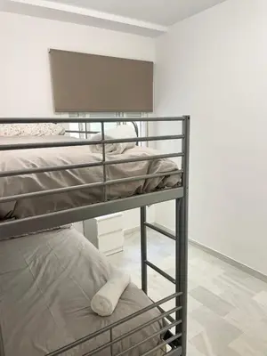 a couple of bunk beds in a room at Encantador y céntrico piso con garaje in Sanlúcar de Barrameda