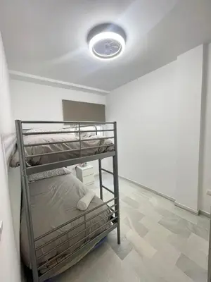 a bedroom with two bunk beds in a room at Encantador y céntrico piso con garaje in Sanlúcar de Barrameda