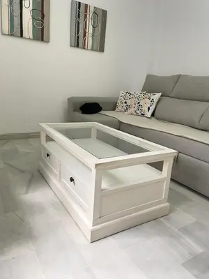 a white coffee table in a living room with a couch at Encantador y céntrico piso con garaje in Sanlúcar de Barrameda