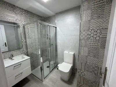 a bathroom with a toilet and a shower and a sink at Apartamento Completo en Chipiona in Chipiona