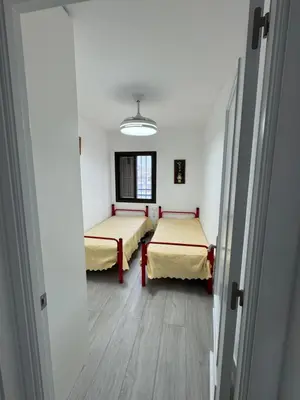 a hospital room with two beds and a window at Apartamento Completo en Chipiona in Chipiona
