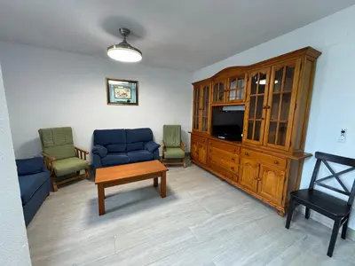 a living room with a couch and a tv at Apartamento Completo en Chipiona in Chipiona