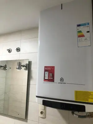 an apple machine in a bathroom next to a mirror at Puerto centro in El Puerto de Santa María