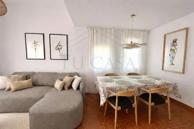 a living room with a couch and a table at Ático Jardín del Golf, Casa Alma in Chiclana de la Frontera