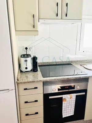 a kitchen with a stove and a toaster at Ático Jardín del Golf, Casa Alma in Chiclana de la Frontera