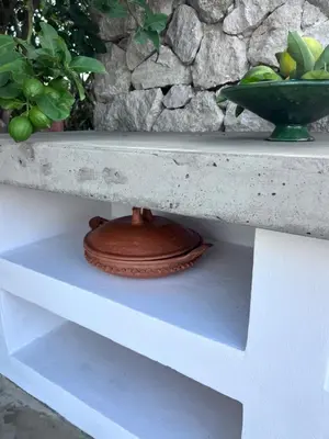 a white shelf with a vase on top of it at Casa Chica Boutique in Sanlúcar de Barrameda