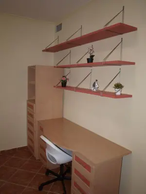 an office with a wooden desk and shelves at Corales 6 in El Puerto de Santa María