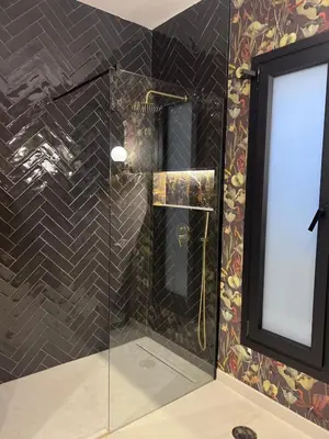 a shower with a glass door in a bathroom at Casa Chica 2 in Sanlúcar de Barrameda