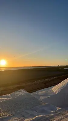 a sunset over a snowy field with the sun in the background at Casa Chica 2 in Sanlúcar de Barrameda