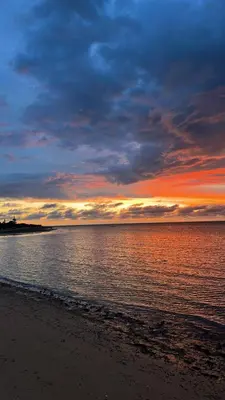 a sunset over the ocean with a sandy beach at Casa Chica 2 in Sanlúcar de Barrameda