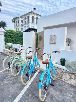 three bikes parked in a parking lot in front of a building at Casa Chica 2 in Sanlúcar de Barrameda