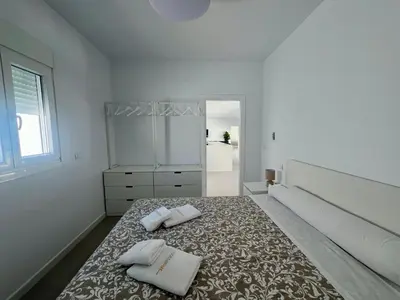 a bedroom with a bed with two towels on it at El Paraíso in Chiclana de la Frontera
