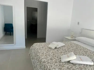 a bedroom with a bed with two towels on it at El Paraíso in Chiclana de la Frontera