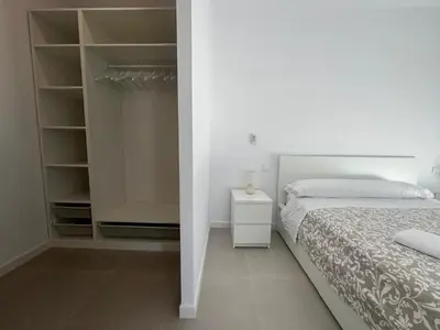 a bedroom with a bed and a walk in closet at El Paraíso in Chiclana de la Frontera