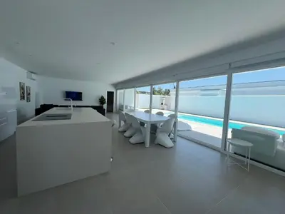 a white kitchen with a view of the ocean at El Paraíso in Chiclana de la Frontera