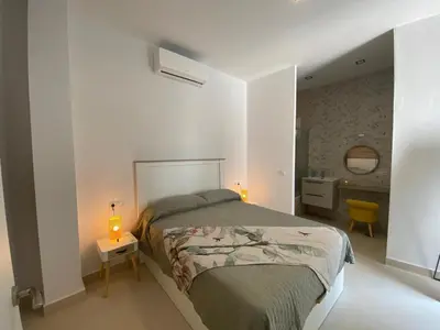 a bedroom with a bed and two lamps on a table at Sol Sherry in Jerez de la Frontera
