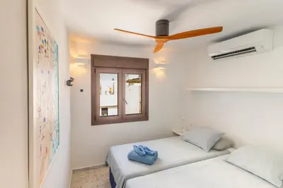 a bedroom with a bed and a ceiling fan at Cadizz - Ático del Búho Surenyo - Terraza 100m2 privada in Cádiz