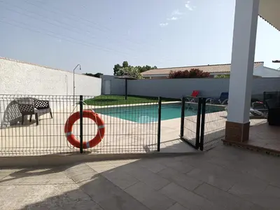 a fence with a red ring on it next to a pool at Lakuarta in Hozanejos