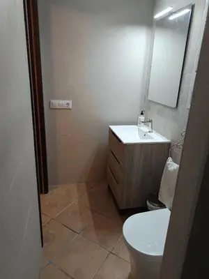 a bathroom with a toilet and a sink and a mirror at Lakuarta in Hozanejos