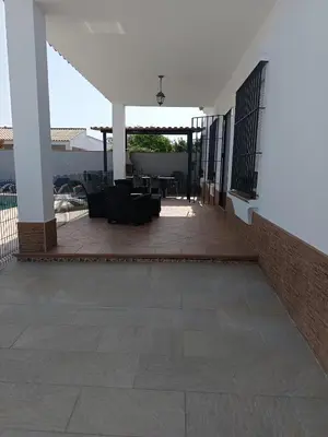 a patio with chairs and tables in a building at Lakuarta in Hozanejos