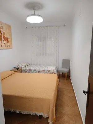 a bedroom with two beds and a window at Lakuarta in Hozanejos