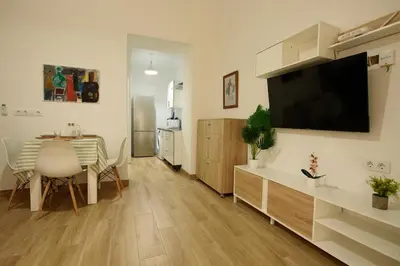a bed in a room with two paintings on the wall at Luz del Sur en El Puerto de Santa María desde el corazón de su casco histórico in El Puerto de Santa María