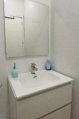 a white bathroom with a toilet and a shower at Luz del Sur en El Puerto de Santa María desde el corazón de su casco histórico in El Puerto de Santa María