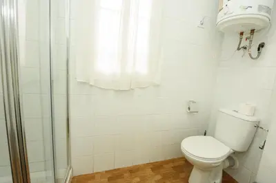a kitchen with white cabinets and a sink at Luz del Sur en El Puerto de Santa María desde el corazón de su casco histórico in El Puerto de Santa María