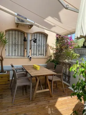 a wooden table and chairs on a patio at Puerto Sherry Bali in El Puerto de Santa María