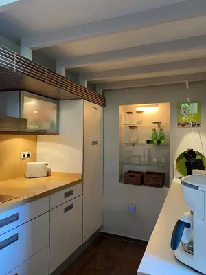 a kitchen with white cabinets and a sink at Puerto Sherry Bali in El Puerto de Santa María