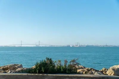 a large body of water with a bridge in the distance at Puerto Sherry Bali in El Puerto de Santa María