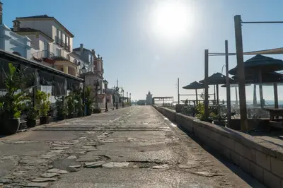 an empty street with buildings on the side at Puerto Sherry Bali in El Puerto de Santa María