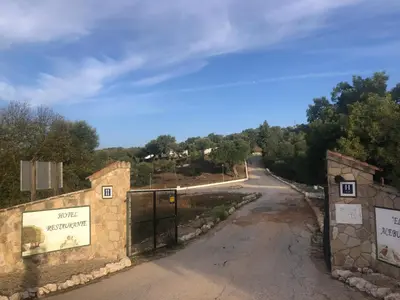 an empty road with a gate on the side at Grupo El Duende A&G in San Jose del Valle