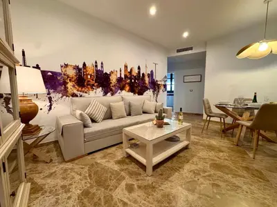 a living room with a couch and a table at inncadiz El Refugio de Gadir in Cádiz
