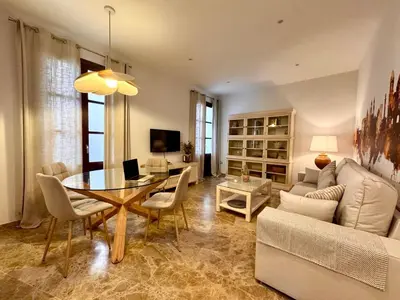 a living room with a table and a couch at inncadiz El Refugio de Gadir in Cádiz