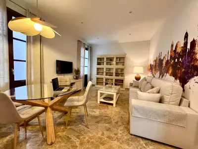 a living room with a table and a couch at inncadiz El Refugio de Gadir in Cádiz