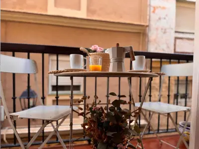 a table with a coffee maker on a balcony at inncadiz El Refugio de Gadir in Cádiz