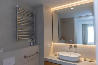 a bathroom with a sink and a mirror at GINVA - Luxury Beachfront Apartment in El Puerto de Santa María