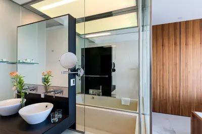 a bathroom with a glass shower and a sink at Parador de Cádiz in Cádiz